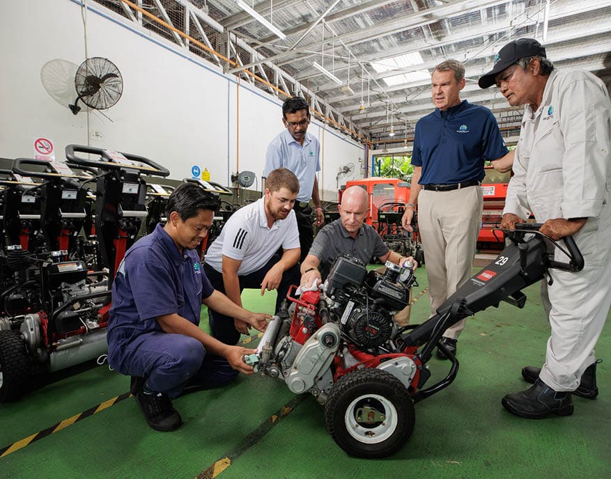 A group of men are working on a small red vehicle. AI generated content