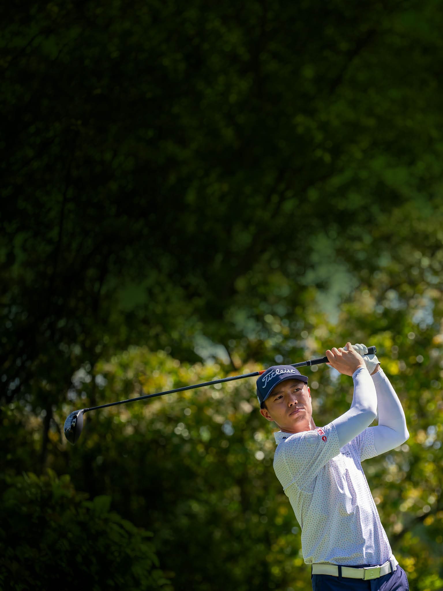 A man is swinging a golf club on a golf course. AI generated content