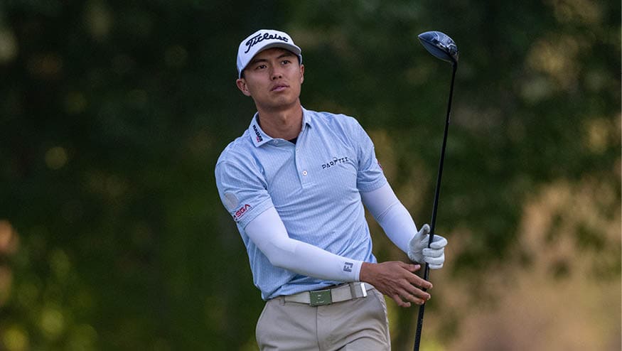 A man in a blue shirt and white pants is holding a golf club and preparing to swing. AI generated content