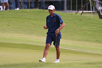 A man in a blue shirt and shorts is walking on a golf course. AI generated content